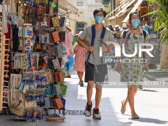 Tourists wearing face coverings walk in Central Athens amid the second wave of the pandemic in Athens, 20 September 2020. (