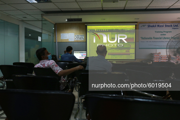 Investors look at the screens during trading hours in a brokerage house in Dhaka, Bangladesh on September 20, 2020. 