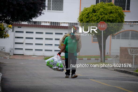 Mr. Botache belongs to the group of Environmental Recuperators walks through the streets of the town of San Cristobal on a collection day in...