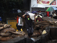 Residents carries a food package to distribute to families in flash flood hit in Cibuntu, Pesawahan village in Sukabumi, West Java, Indonesi...