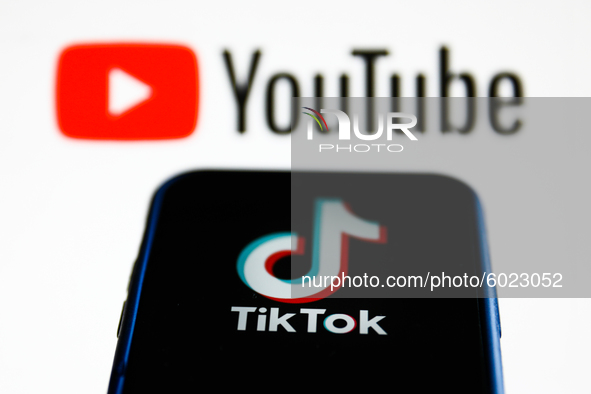 TikTok logo is seen displayed on a phone screen with YouTube logo in the background in this illustration photo taken on September 22, 2020 i...