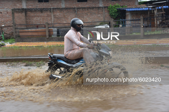 A biker wades through a waterlogged street following heavy rainfall, at Boragaon in Guwahati ,india on Tuesday, Sept. 22, 2020.  