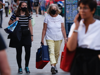 Women wearing face masks walk along Regent Street in London, England, on September 22, 2020. British Prime Minister Boris Johnson this after...