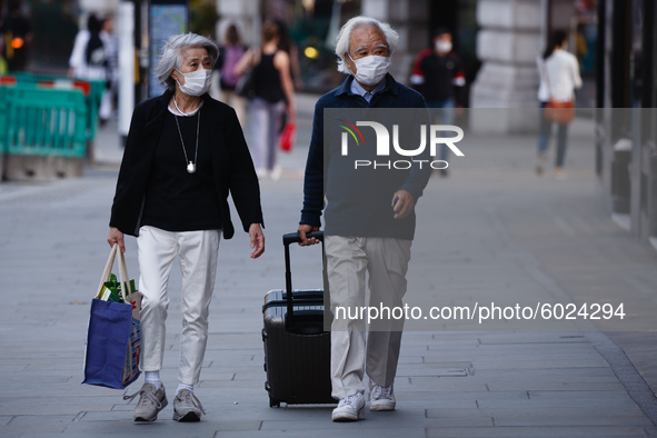 An elderly couple wearing face masks walk along Regent Street in London, England, on September 22, 2020. British Prime Minister Boris Johnso...