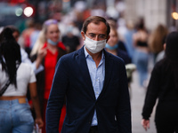 A man wearing a face mask walks along Regent Street in London, England, on September 22, 2020. British Prime Minister Boris Johnson this aft...
