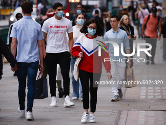 Shoppers, some wearing face masks, walk along Regent Street in London, England, on September 22, 2020. British Prime Minister Boris Johnson...