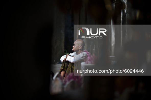 Portrait of a Buddhist Monk during prayer in Phnom Penh, Cambodia, in April 2016. 