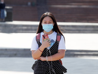 A young woman wearing a protective face mask amid the COVID-19 coronavirus epidemic walks in Kyiv, Ukraine on 23 September 2020.  (