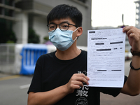 Pro-Democracy activists Joshua Wong holdsup his bail form  on September 24, 2020 in Hong Kong, China. Joshua Wong was arrested for taking pa...