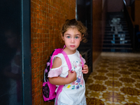 A little girl waiting to go to school, on the first day, waits for her mother down at the front door, in Molfetta, Italy, on 24 September 20...