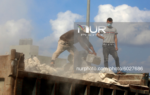 Palestinian workers remove debris from a house, amid the coronavirus disease (COVID-19) crisis, in Gaza City on  September 24, 2020.  