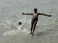 India boy jump Ganga River of a cool water on a hot day in Kolkata, India, Saturday, May 23, 2015. Heat wave conditions prevailed as tempera...
