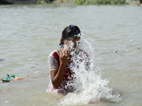 India Girl Ganga River of a cool water on a hot day in Kolkata, India, Saturday, May 23, 2015. Heat wave conditions prevailed as temperature...