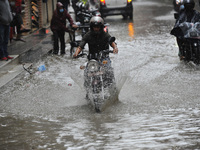 A Motorbike travelling through a water logged road at Lalitpur, Nepal on Thursday, September 24, 2020. Due to the poor water drainage manage...