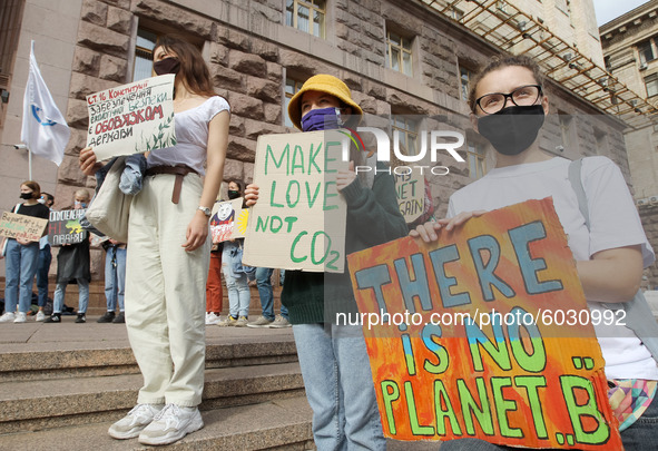 Protestors hold placards as they attend the 'Global Day of Climate Action' rally near the City Hall in Kyiv, Ukraine on 25 September 2020. U...