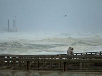 A woman is walking and  watching the stormy ocean in Hossegor, France, on September 25, 2020. Since friday morning, 25th of September, a big...