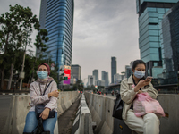 Womans wear protective face mask waiting transport in Central Business District in Jakarta on Friday 25 September 2020. For the third day in...