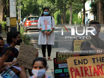 Demonstrators hold placards take part in a protest against climate change outside Ministry of Environment, to demand Climate Action during t...