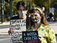 Demonstrators display posters denouncing pollution and the danger of climate change, at a meeting in Lisbon, Portugal. September 25th, 2020....