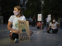 A girl with a sign that says ‘Make earth cool again’ during a pacific concentration in Plaza del Carmen Square on September 25, 2020 in Gran...