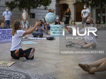 Two protesters play with a ball shaped like a planet earth during a pacific concentration in Plaza del Carmen Square on September 25, 2020 i...