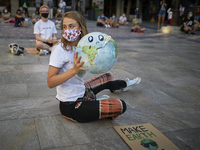 A girl with a ball shaped like a planet earth during a pacific concentration in Plaza del Carmen Square on September 25, 2020 in Granada, Sp...