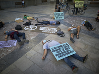 Protesters lying on the floor with signs that says ‘When the permafrost thaws, greenhouse gases, viruses ... are released.’ during a pacific...