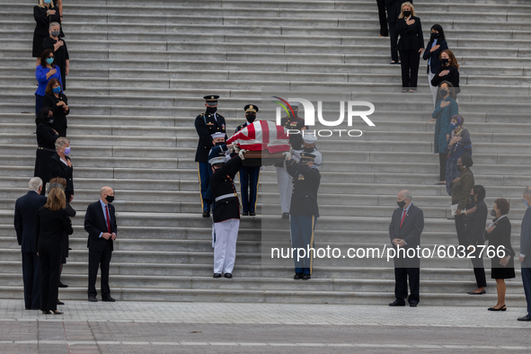 Women members of Congress look on as the casket of the late Supreme Court Associate Justice Ruth Bader Ginsburg is driven away following cer...