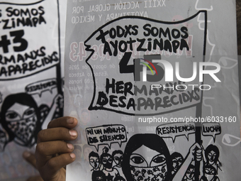 A demonstrator holds a poster during a protest in Mexico City on September 25, 2020, on the eve of the sixth anniversary of the disappearanc...