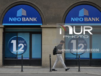 A man wearing a protective mask passes by NeoBank in Krakow's center.
The number of COVID-19 infected in Poland is constantly growing, and t...