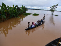 Flood-affected villagers are transported by boat to safety at Kachua village in Nagaon district, in the northeastern state of Assam, India,o...