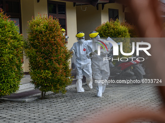 Medical officers walk towards the treatment room at the Institute for Quality Improvement of Education (LPMP) building which has been conver...