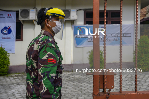A soldier stands guard at the door of the treatment room at the Institute for Quality Improvement of Education (LPMP) building which was con...