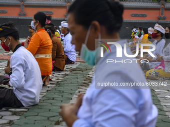 Hindus participate in the ritual of praying for Kuningan Day at Pura Agung Wana Kerta Jagatnatha, Palu, Central Sulawesi Province, Indonesia...