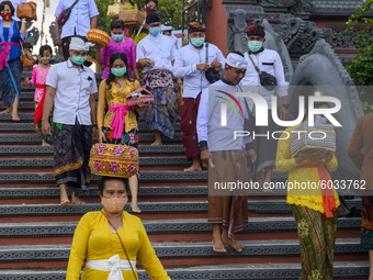 Hindus walk out after participating in the Kuningan Day prayer ritual at Pura Agung Wana Kerta Jagatnatha, Palu, Central Sulawesi Province,...