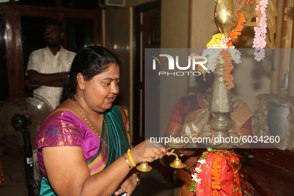 Tamil woman lights a lamp during a special cultural program featuring Tamil children who were orphaned during the civil war take part in a s...