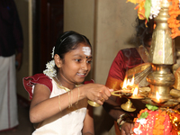 Tamil girl lights a lamp during a special cultural program featuring Tamil children who were orphaned during the civil war take part in a sp...