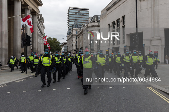  Police forces arrive to disperse protesters after Unite for Freedom rally held in Trafalgar Square in a protest against the restrictions im...