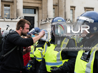  Police clears protesters from Trafalgar Square after Unite for Freedom rally which was held to protest against the restrictions imposed by...