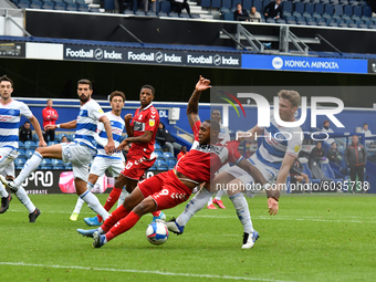 Britt Assombalonga and Rob Dickie in action during the Sky Bet Championship match between Queens Park Rangers and Middlesbrough at The Kiyan...