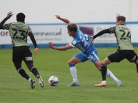      Harrison Biggins of Barrow in action with Colchester United's Kwame Poku and Ben Stevenson during the Sky Bet League 2 match between Ba...