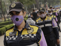 Policewomen from Mexico City guard the march to mark the sixth anniversary of the forced disappearance of the 43 normalistas students in Mex...