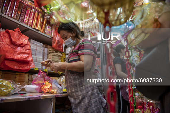 A store owner is seen fixing up a lantern on September 26, 2020 in Hong Kong, China. Mid-Autumn Festival also known as the Lantern Festival...
