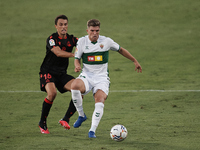 Raul Guti of Elche and Ander Guevara of Real Sociedad compete for the ball during the La Liga Santader match between Elche CF and Real Socie...