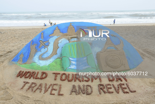 A sand sculpture is seen at the Bay of Bengal Sea's eastern coast beach as it is creating by sand artist Manas Sahoo on the occassion of Wor...