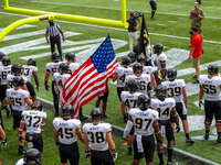 The Army Black Knights football team waits to take to the field before the NCAA college football game at Nippert Stadium between the Univers...