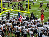 The Army Black Knights football team waits to take to the field before the NCAA college football game at Nippert Stadium between the Univers...
