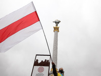 A protestor waves a historical white-red-white flag of Belarus during a rally of solidarity with Belarusian protests on Independence Square...