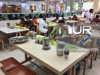 People eat a traditional vegetarian meal at an upscale South Indian restaurant in Nagercoil, Tamil Nadu, India on February 12, 2020. (