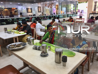 People eat a traditional vegetarian meal at an upscale South Indian restaurant in Nagercoil, Tamil Nadu, India on February 12, 2020. (